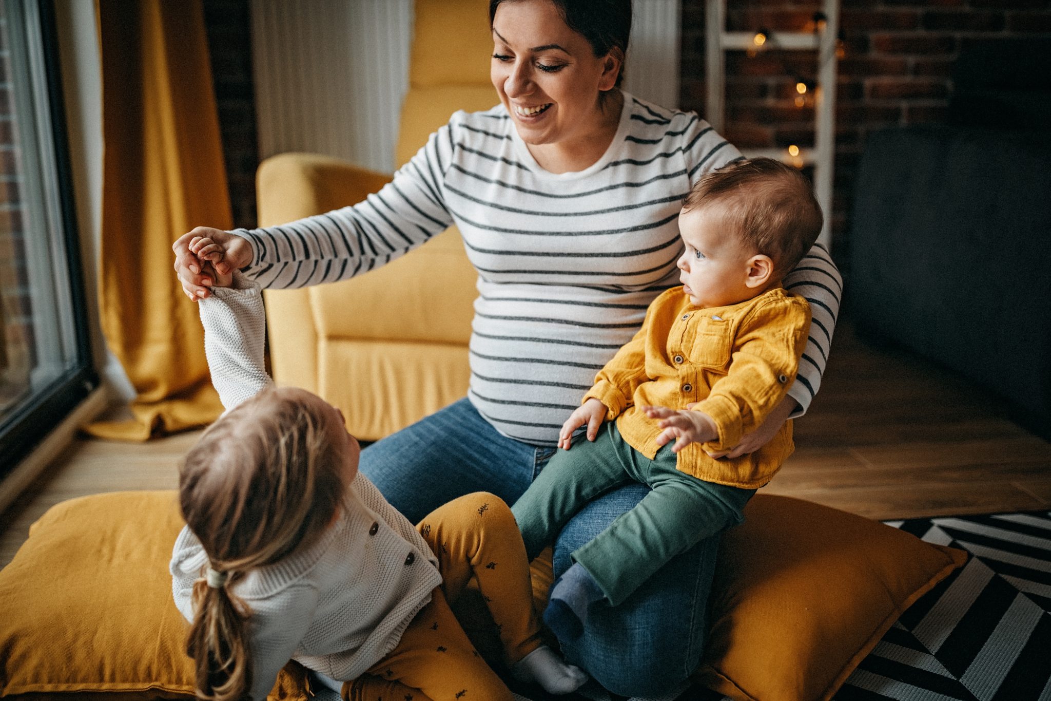 Mother and kids embracing in living room