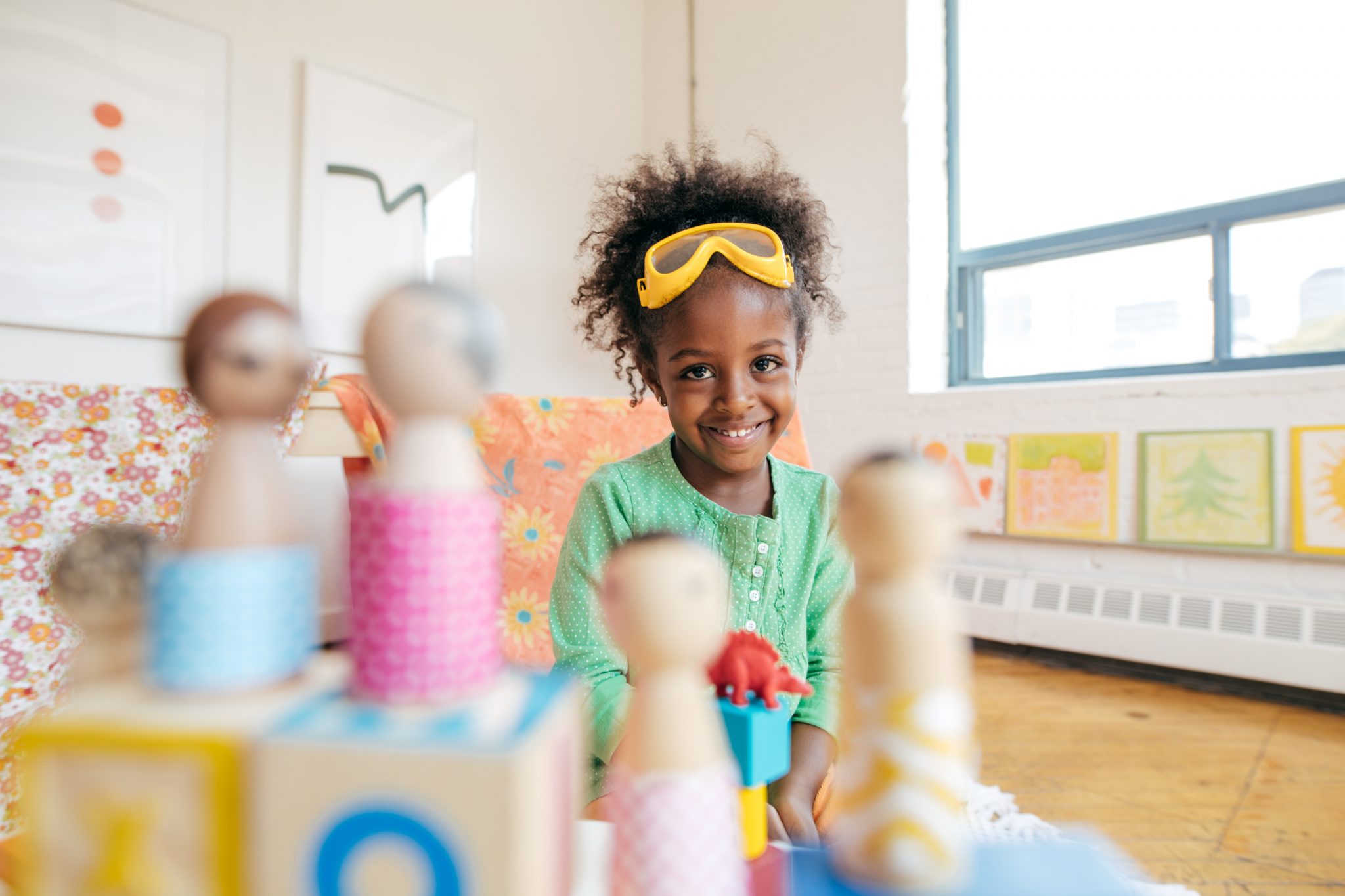 A Girl playing with wooden dolls