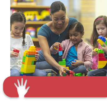 volunteer helping children with building blocks